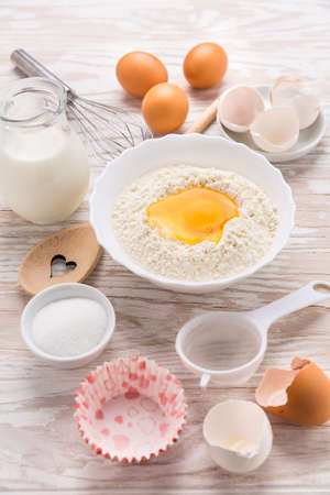Assortment of basic baking ingredients for cake or pancakes on wooden backgroundの写真素材
