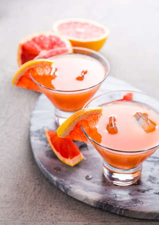 Fresh pink grapefruit drink with juice. Cold summer citrus refreshing drink or beverages with ice.の写真素材