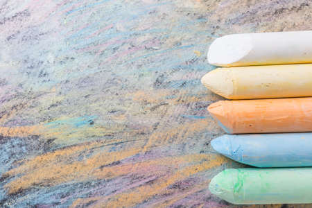 Chalks with colorful painted background. Back to school and art concept with copy space.の写真素材