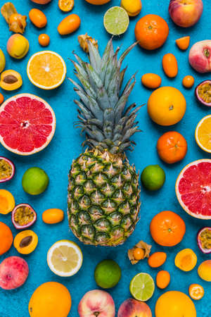Flat lay layout of summer and citrus fruits on blue background.  Healthy eating concept.の写真素材