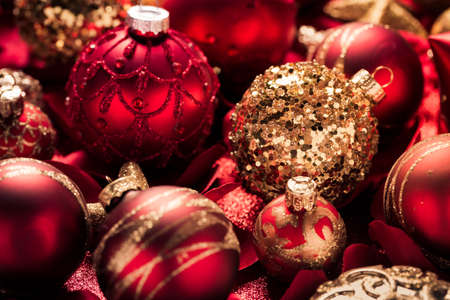 Christmas ornaments and baubles in red and golden tone as backgroundの写真素材