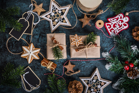 Handmade wrapped christmas gift boxes with decorations and wrapping materialsの写真素材