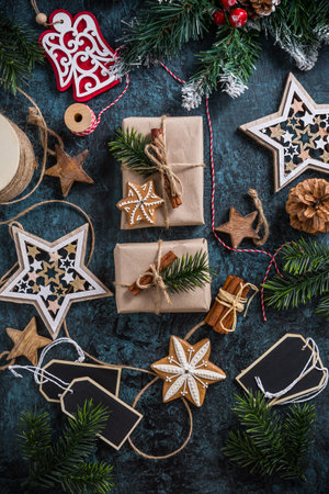 Handmade wrapped christmas gift boxes with decorations and wrapping materialsの写真素材