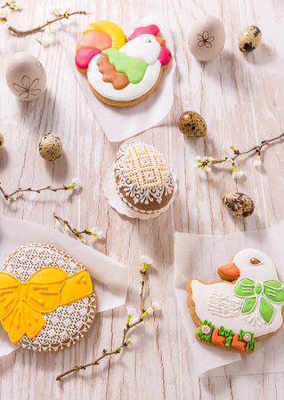 Easter decoration with homemade Easter gingerbread cookies on wooden table