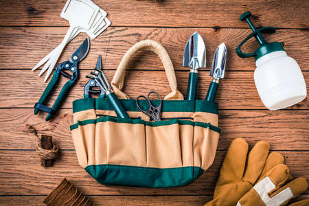 Gardening tools and equipment on wooden backgroundの写真素材
