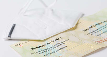 Hockenheim, Germany - February 02, 2021: Closeup of german government entitling certificate (berechtigungsschein) for ffp2 protection masks purchase warrantのeditorial素材