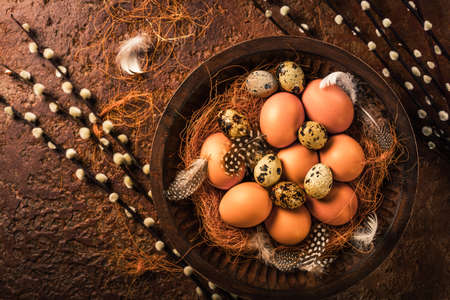 Eggs with pussy willow branches on rustic background. Easter table decoration.の写真素材