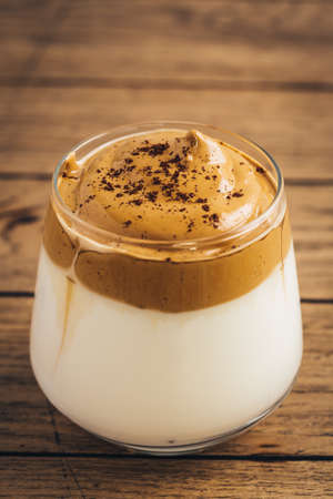 Iced fluffy creamy whipped trend drink with coffee foam and milk. Dalgona coffee.の写真素材