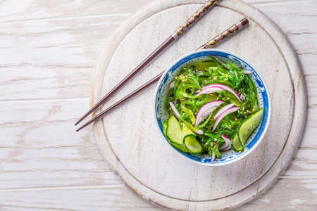 Japanese cucumber and wakame salad with red onions and sesame seedsの写真素材