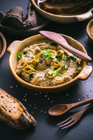 Arabic food: Aubergine paste or dip Baba Ghanoush with olives and sesame seedsの写真素材