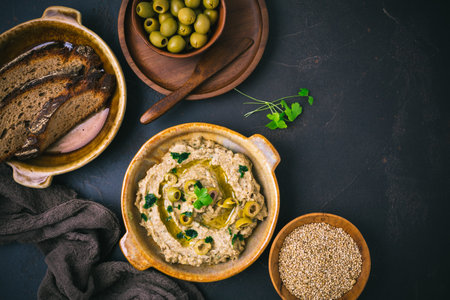 Arabic food: Aubergine paste or dip Baba Ghanoush with olives and sesame seeds