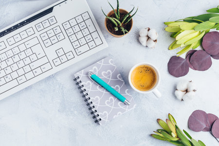 Cup of coffee, with communication device with and writing tools. Flat lay home business desk ....