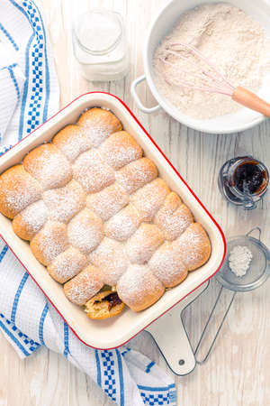 Sweet rolls, Buchteln filled with plum jam or jelly with backing ingredientsの写真素材