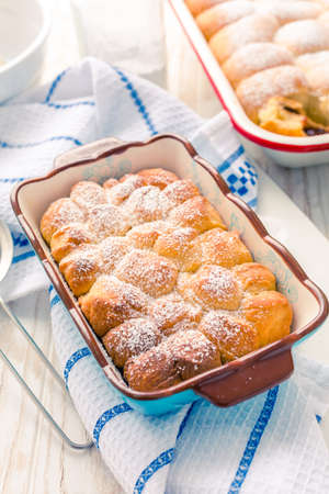 Sweet rolls, Buchteln filled with plum jam or jelly with backing ingredientsの写真素材