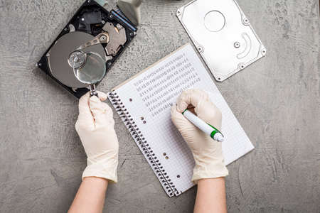 Concept of data recovery, engineer is recovering data from failed hard disk driver.の写真素材