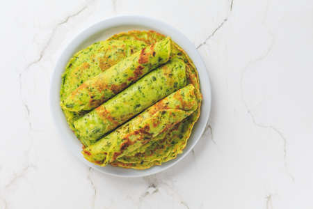 Delicious homemade ramson pancakes or crepes on whiteの写真素材