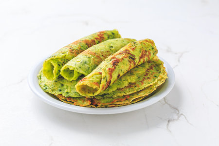 Delicious homemade ramson pancakes or crepes on white background