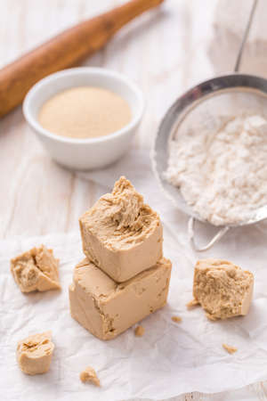 Fresh and dried yeast with baking ingredients on whiteの写真素材