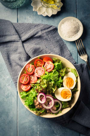 Salad bowl with tuna, egg, tomato and onions - healthy foodの写真素材