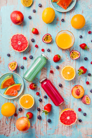 Variation of smoothies and refreshing drinks with fresh fruits for hot summer on blue backgroundの写真素材