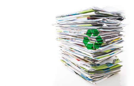 Stack of waste paper, old magazines, newspapers and leaflets for recycling isolated on whiteの写真素材