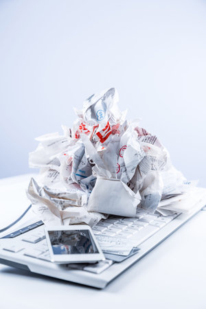 Pile of shopping receipts with phone and keyboard