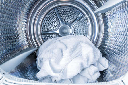 IInside of tumble dryer with clean white towels - new generation of dryer,  household conceptの写真素材