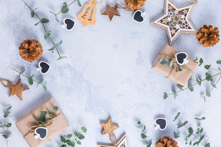 Holiday Christmas Gifts with Boxes, Coniferous, eucalyptus and ornaments on snowy backgroundの写真素材