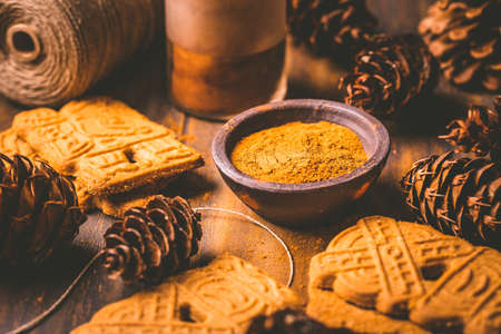 Gingerbread spice mix and seasoning for gingerbread cookies for Christmas on wooden backgroundの写真素材