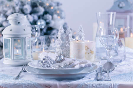 Festive Christmas table or place setting in snowy whiteの写真素材