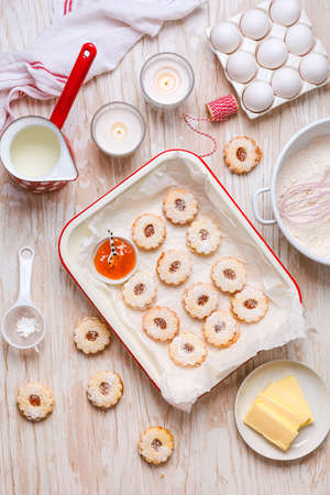 Homemade Christmas cookies with baking ingredients in whiteの写真素材