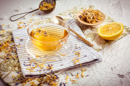 Cup of herbal tea with lemon, dried herbal leavesの写真素材