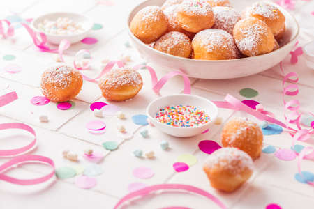 Krapfen, Berliner and donuts with streamers and confetti. Colorful carnival, birthday and Fasching imageの写真素材