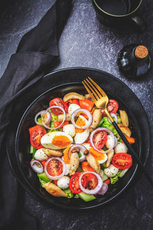 Mixed salad with roasted mushroomes, egg and mozzarella. Low carb eating.の写真素材