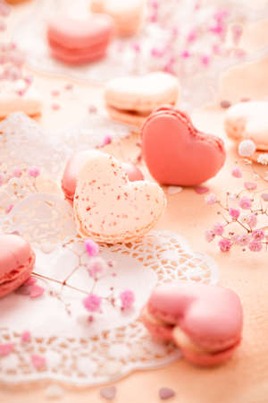 Happy Mothers Day - sweet macarons in heart shape with flowers in pink toneの写真素材