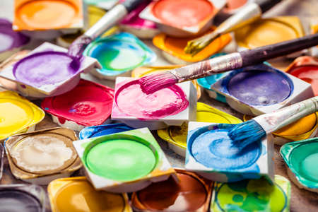 Colors and brushes on wooden backgroundの写真素材
