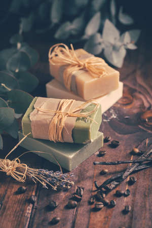 Natural organic soap bars with vanilla, coffee beans and eucalyptus on wooden backgroundの写真素材