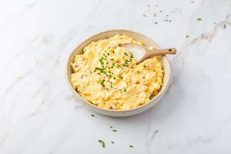 Homemade egg spread with onion, bacon and chives on marble backgroundの写真素材