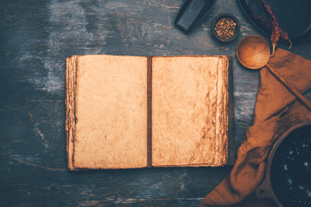 Empty menu or cookbook and kitchen utensils on wooden table, vintage styleの写真素材