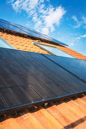 Photovoltaic panels on the roof of family house, solar panels. Environment and technology concepts.の写真素材