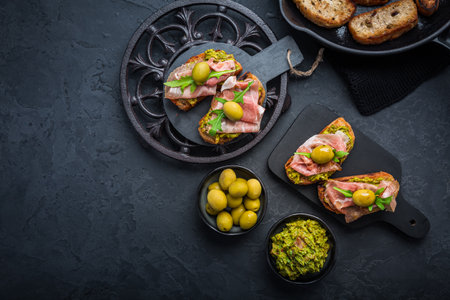 Delicious crostini with avocado spread and serrano or prosciutto hamの写真素材