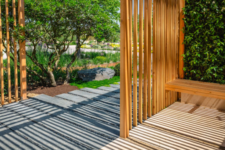 Modern wooden arbor. Modern wooden gazebo in courtyard, backyard. Urban gazebo, relaxing garden design.の写真素材