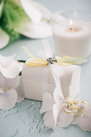 Confirmation or First holy communion concept  - small present with candle and flowersの写真素材