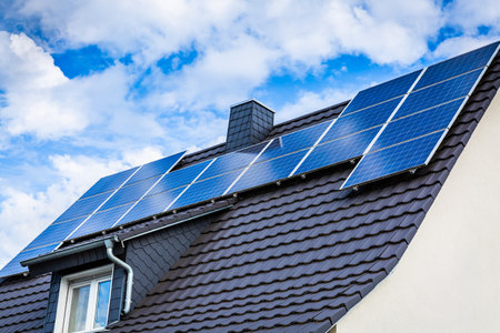 Photovoltaic panels on the roof of family house, solar panels. Environment and technology concepts.の写真素材