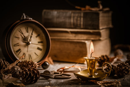 Vintage still life with  antique  books, clock and candle. Halloween and occult concept.の写真素材