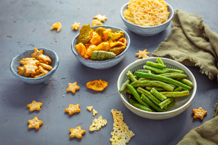 Bowls of healthy colorful vegetables and parmesan cheese chipsの写真素材