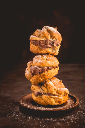 Profiteroles or cream puff filled with chocolate cream, French choux pastry ball