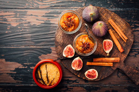 Homemade fig jam or jelly in a jar with cinnamon, vanilla and brown sugarの写真素材