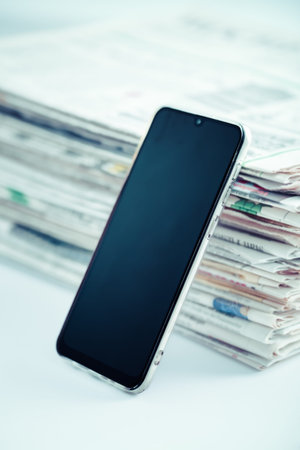 Concept of new online press. Newspapers or magazines with cellphone. Latest daily press and media.