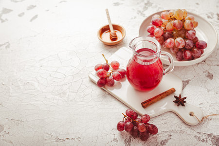 Homemade organic red vinegar with cinnamon and anise. Red grape balsamic vinegar made from fermented fresh grapes.の写真素材